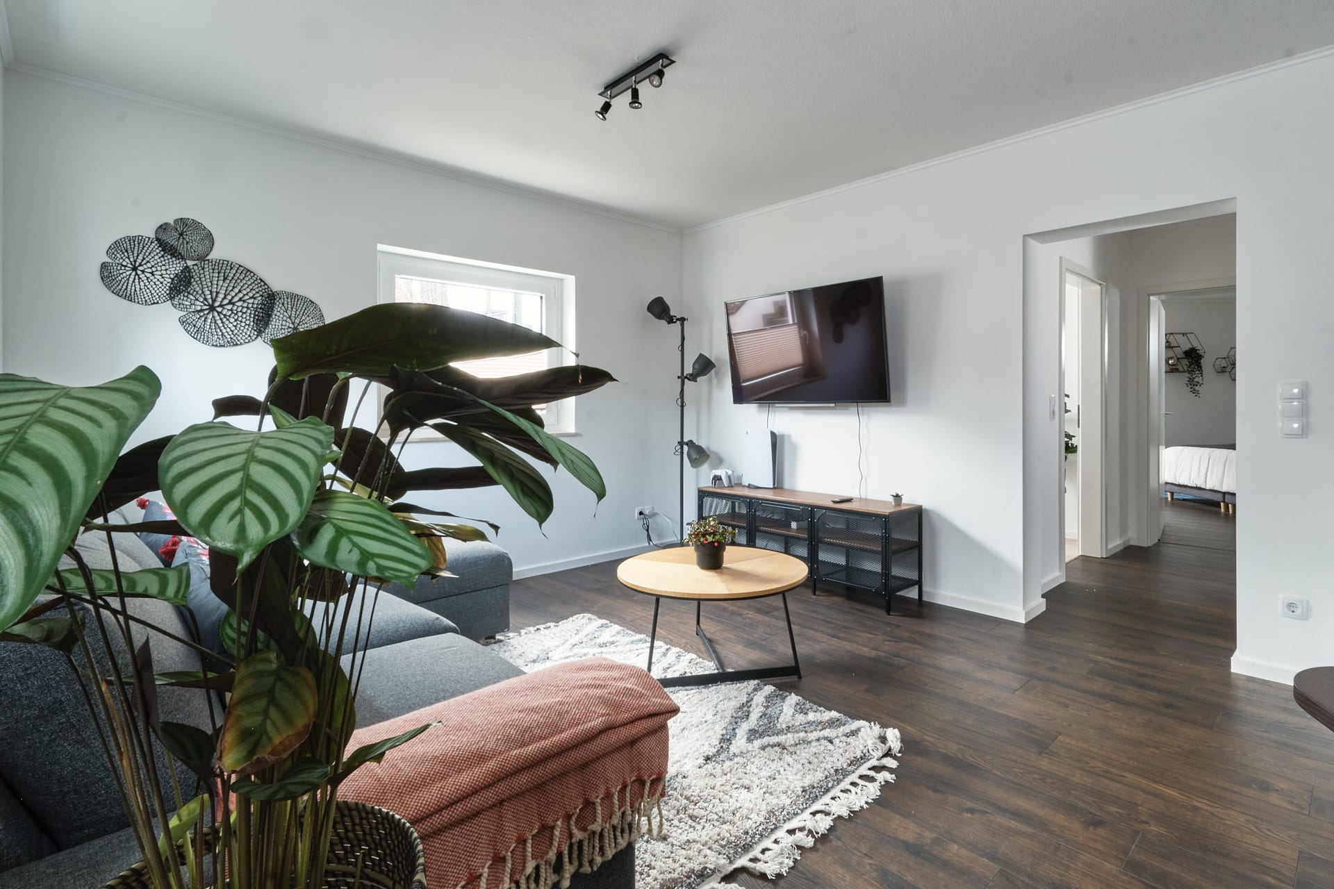 Cozy living room with plants and warm lighting at Mumo's Inn