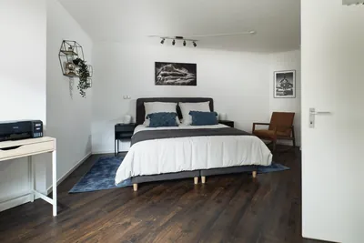 Master bedroom with a large comfortable bed in Landstuhl TLA apartment near Ramstein Air Base