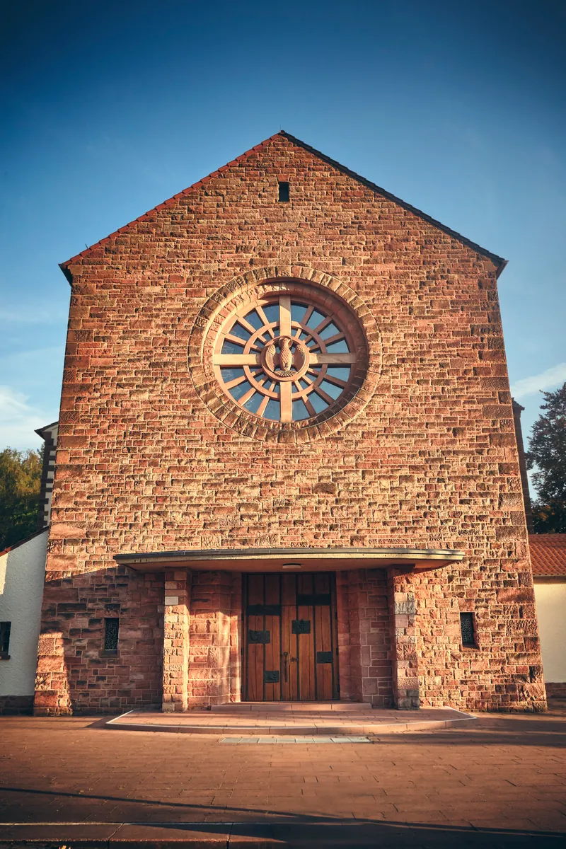 Church facade in Landstuhl with a round rose window