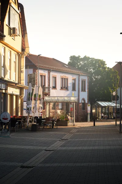 Landstuhl's market square with café awnings at golden hour