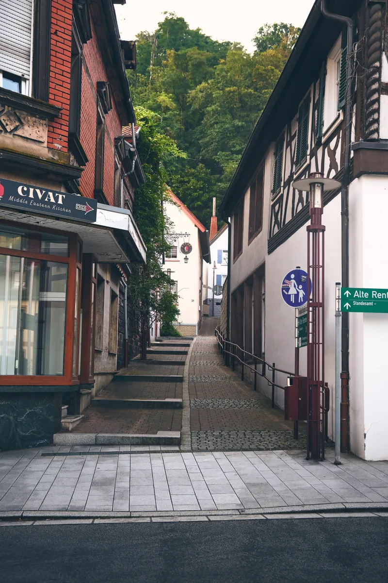 Narrow old-town alley in Landstuhl lined with half-timbered houses and stone steps