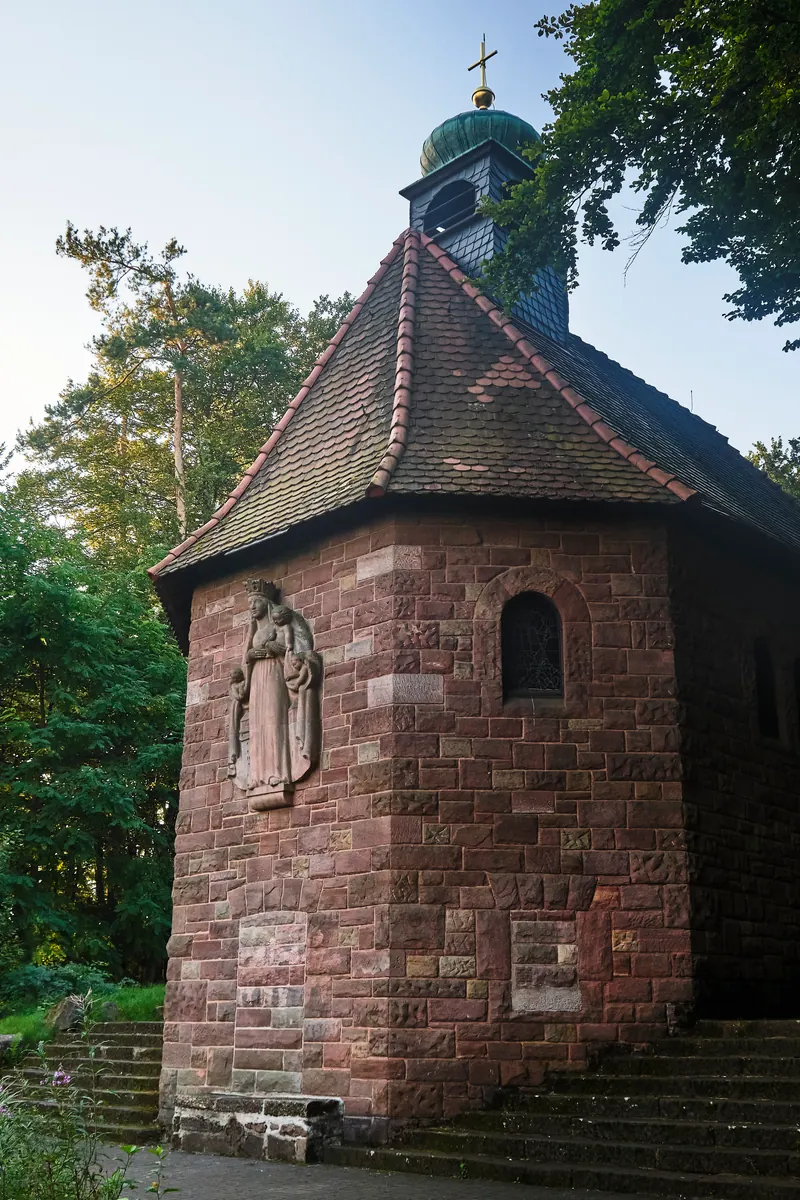 Small sandstone St. Anna chapel with a statue outside